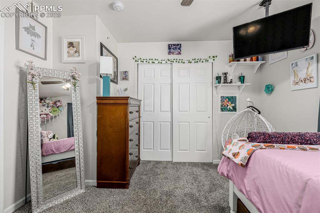Image 20 of 47: Carpeted bedroom with a closet and a ceiling fan