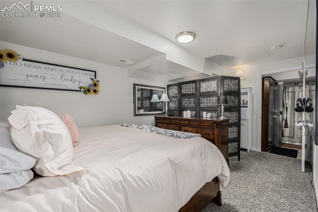 Image 25 of 47: Bedroom with carpet floors