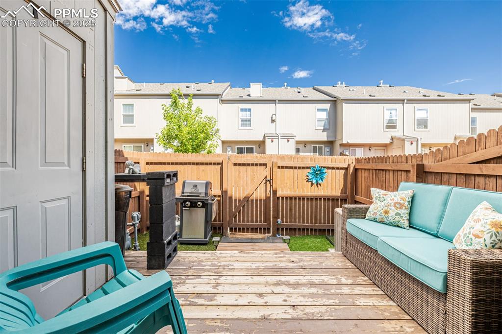Image 29 of 47: Wooden terrace featuring a residential view, outdoor lounge area, a fenced 