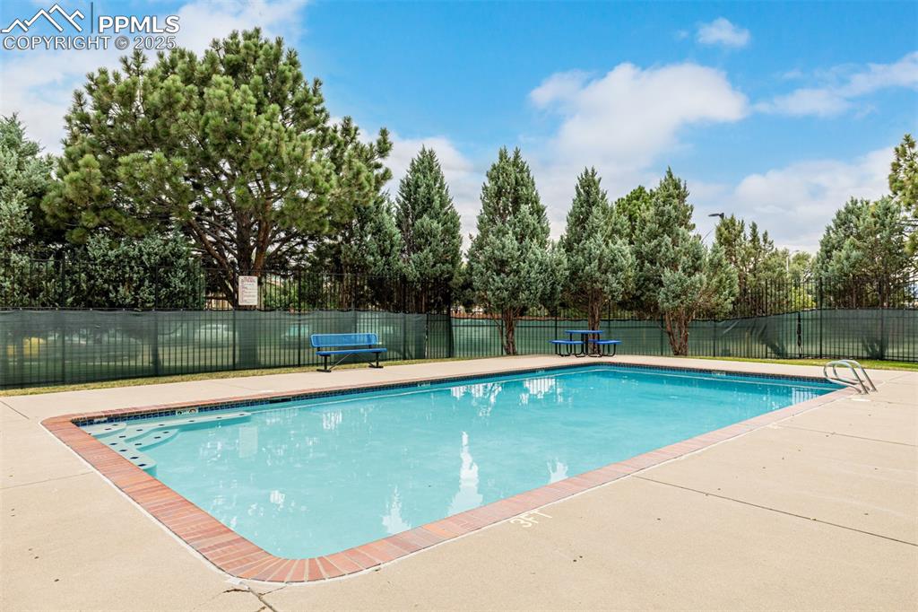 Image 31 of 47: Community pool with a patio
