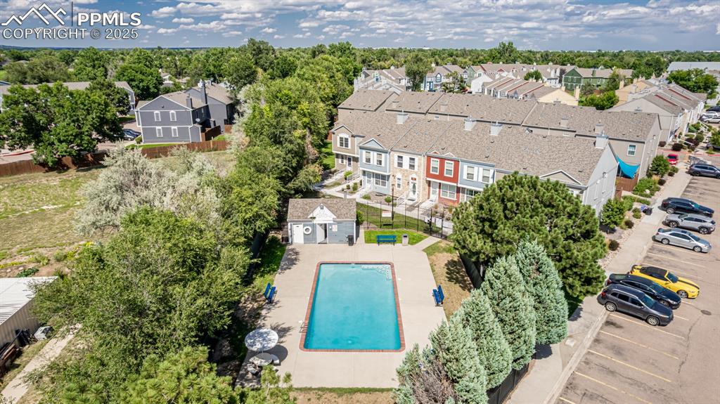 Image 35 of 47: Aerial view of residential area featuring a pool