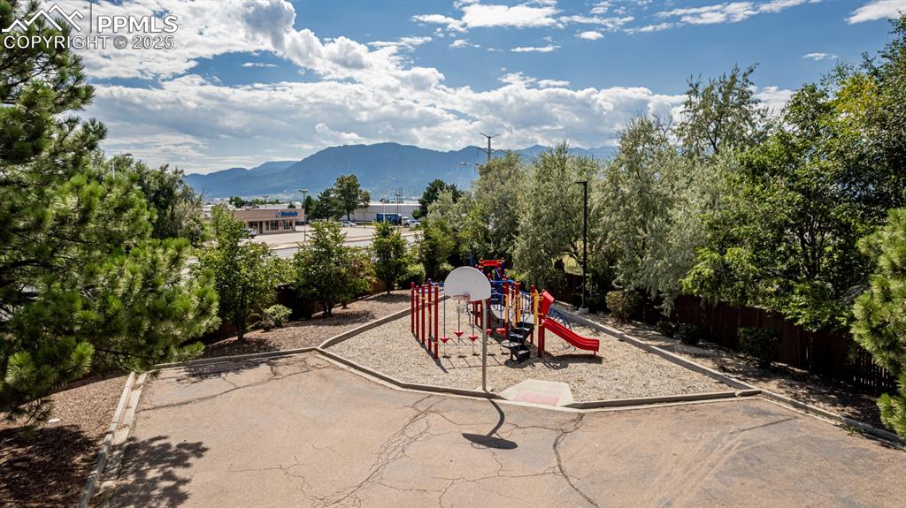 Image 41 of 47: Communal playground featuring a mountain view