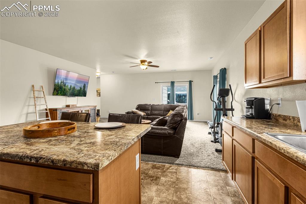 Image 11 of 31: View from the Kitchen opening up to the oversized walk-out Family Room. 