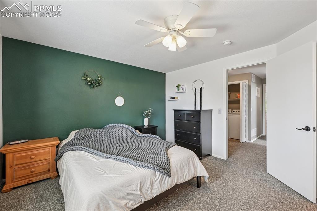 Image 15 of 38: Bedroom with carpet flooring, ceiling fan, and washer / clothes dryer