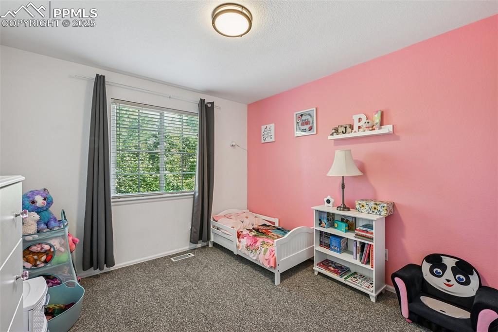 Image 21 of 38: Carpeted bedroom with baseboards