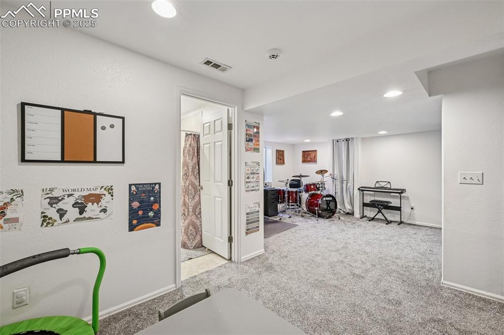 Image 24 of 38: Game room with an office area, light colored carpet, recessed lighting, and