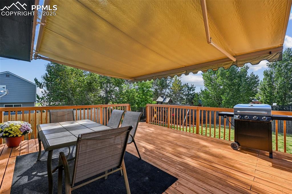 Image 3 of 38: Deck featuring outdoor dining space and area for grilling