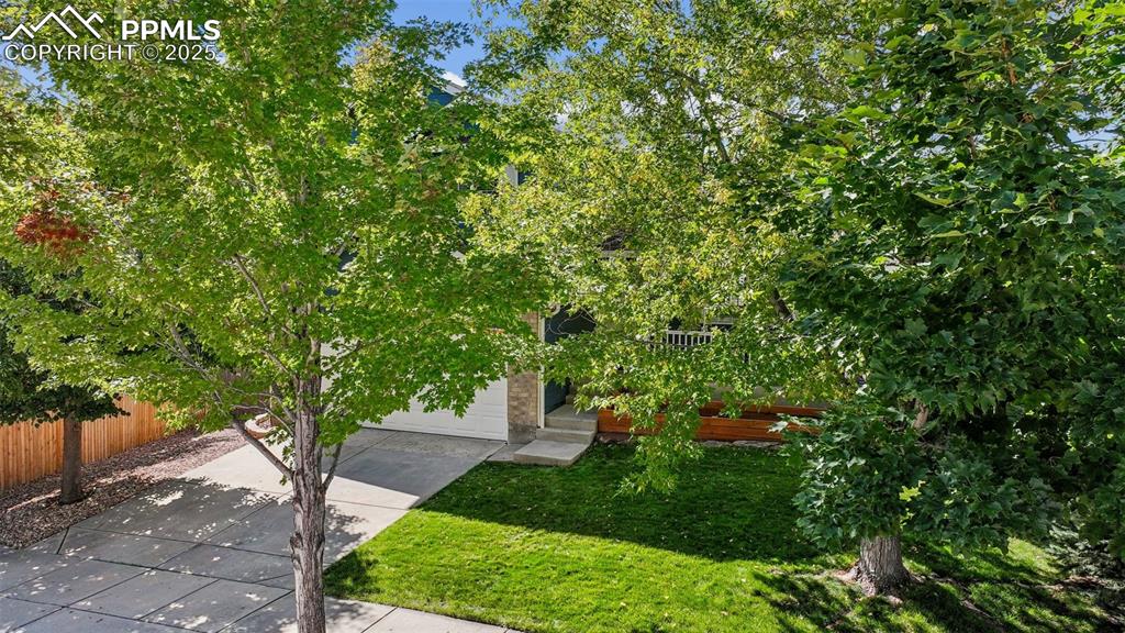 Image 30 of 38: View of front of property featuring concrete driveway and a garage
