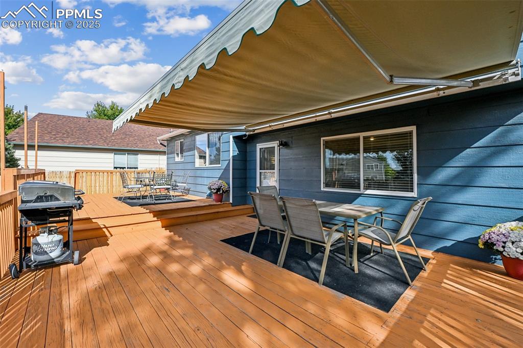 Image 32 of 38: Deck with outdoor dining area and grilling area