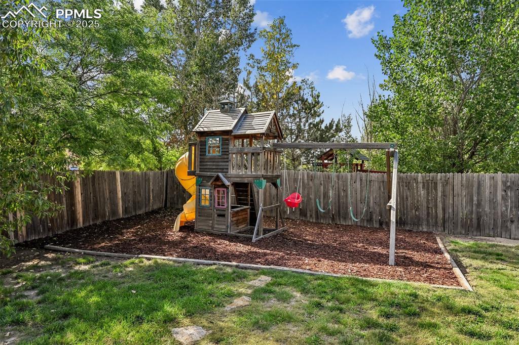 Image 33 of 38: View of play area featuring a fenced backyard