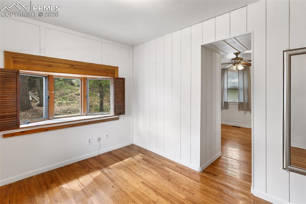 Image 17 of 49: One of 2 bedrooms - this one features real wood flooring and a bay window.