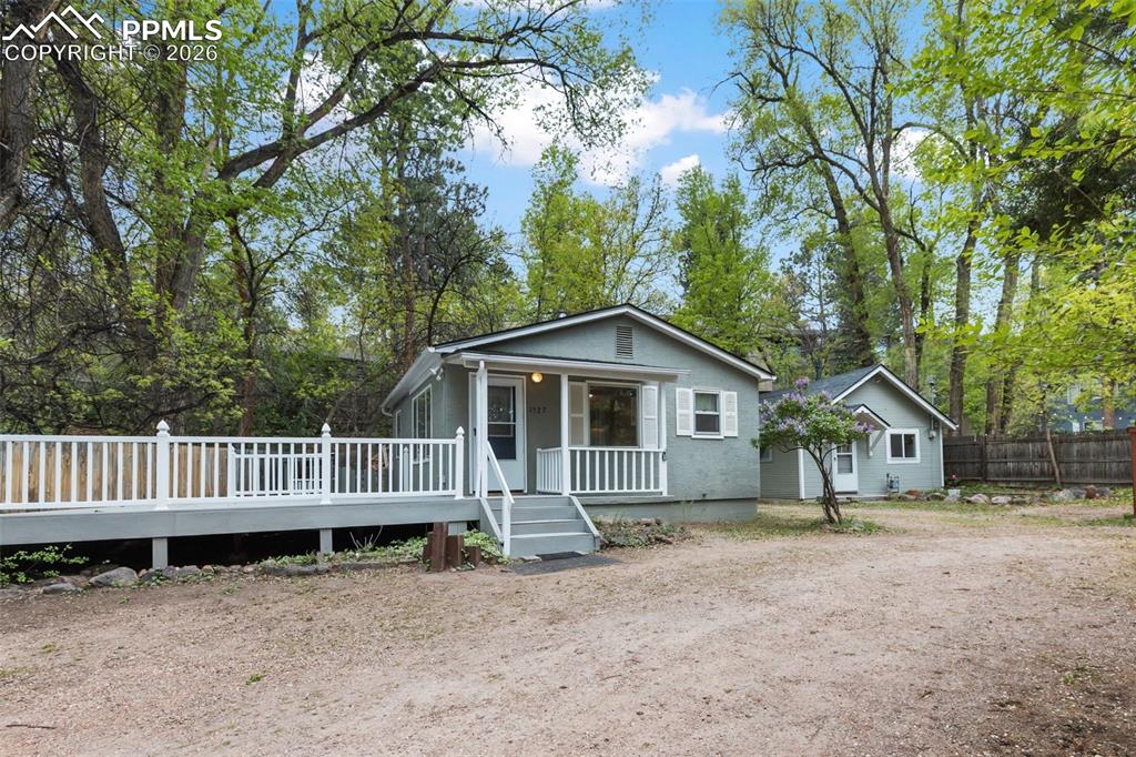 Image 2 of 49: Wonderfully private 2 bedroom 1 bath cottage with expansive composite deck 