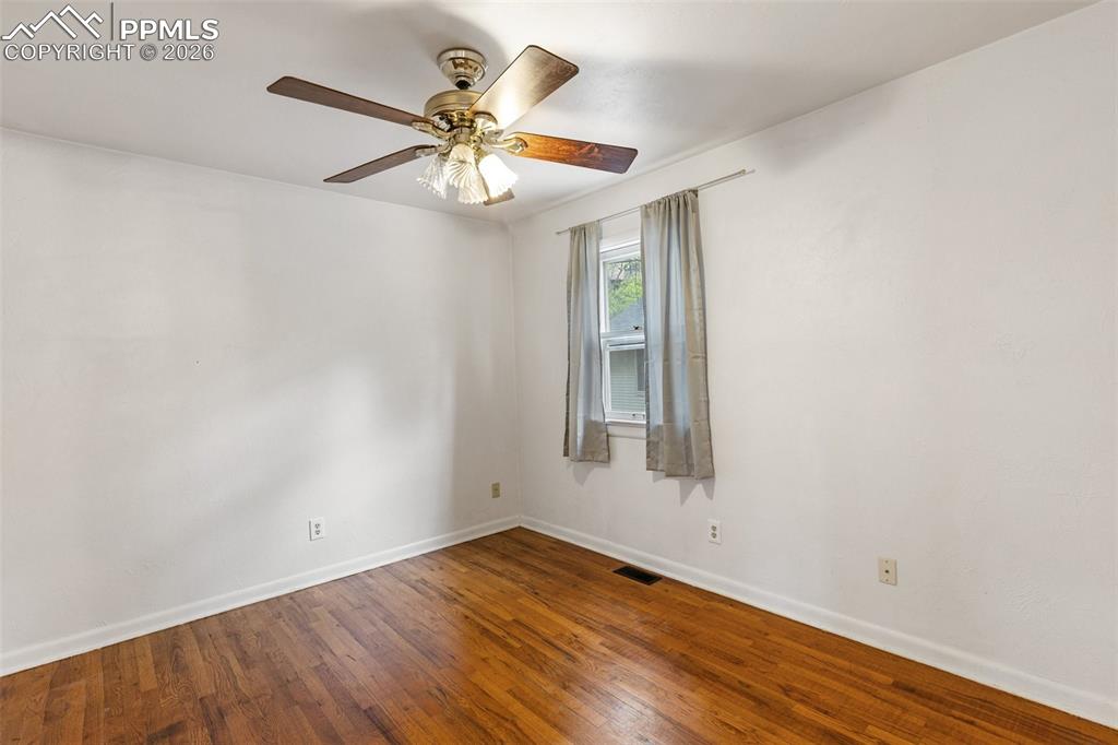 Image 25 of 49: One of 2 bedrooms with real wood flooring