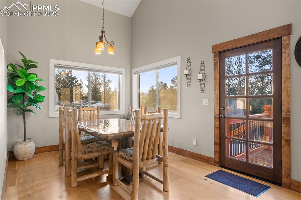Image 11 of 50: Dining room area with white oak hardwood flooring and views of Pikes Peak