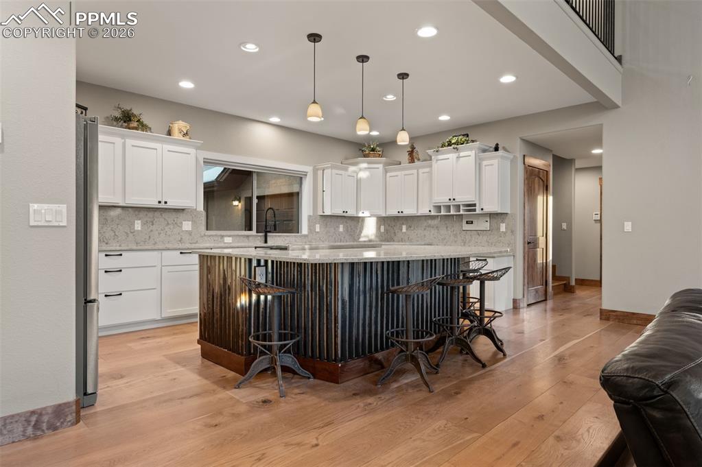 Image 12 of 50: Fully remodeled kitchen with new island, cupboards and countertops & backsp