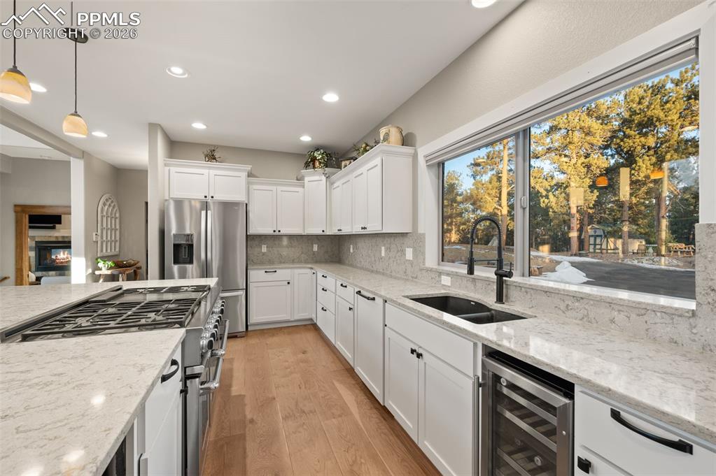 Image 14 of 50: Kitchen with newer appliances and wine refrigerator
