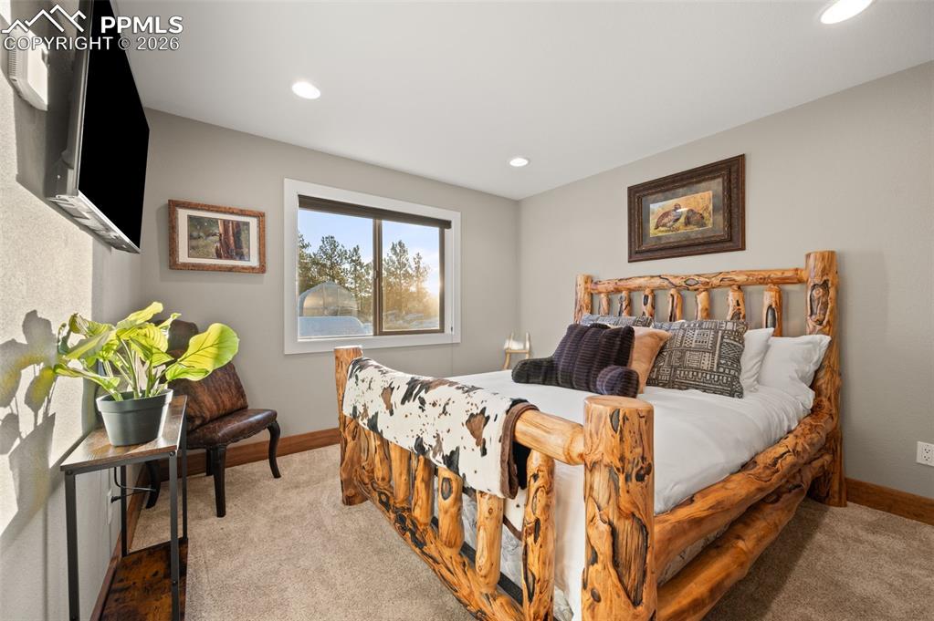 Image 23 of 50: Second bedroom on main floor with new carpet, new doors and closets with a