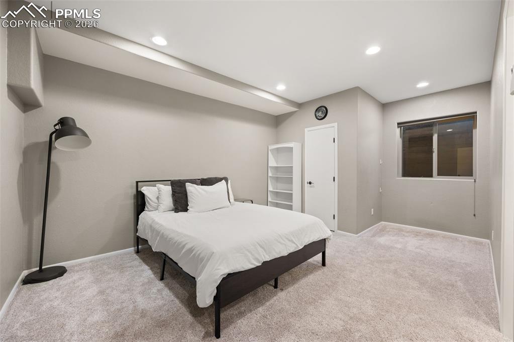 Image 32 of 50: Large, spacious bedroom that connects to vanity and sink, then to bathroom.