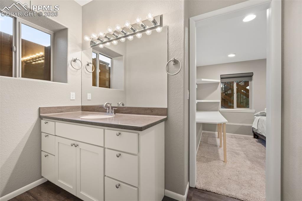 Image 33 of 50: First lower level bathroom and then the same on other side with shower and