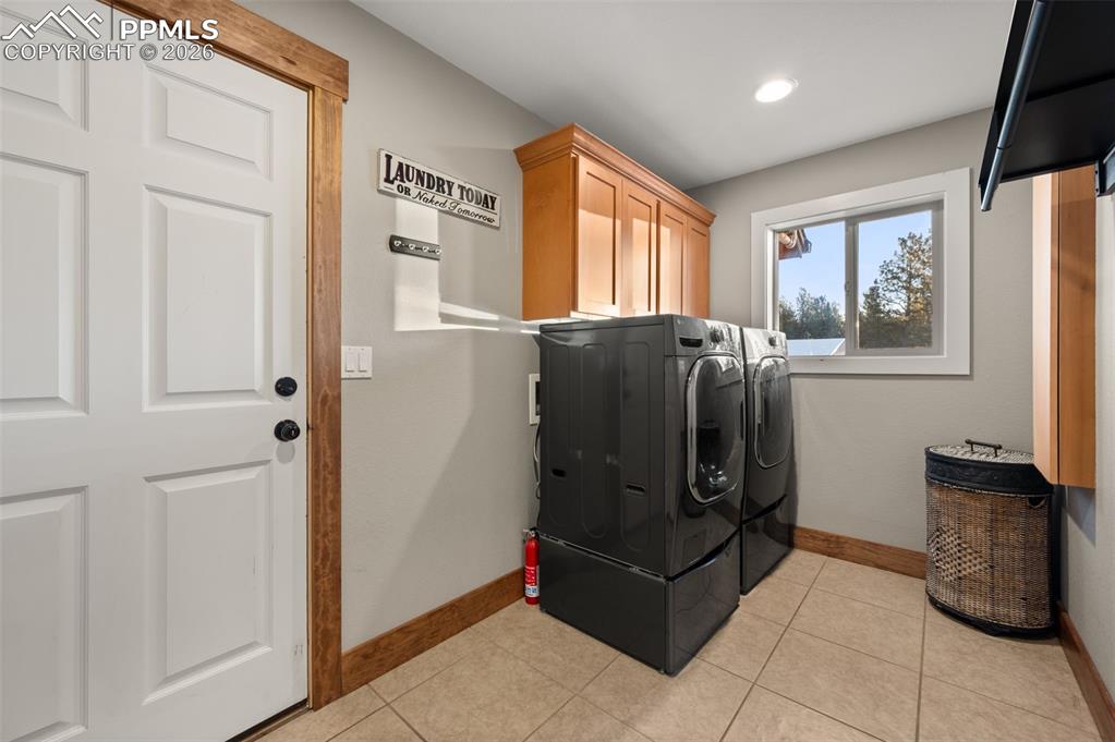 Image 35 of 50: Main level laundry with front loading washer and dryer