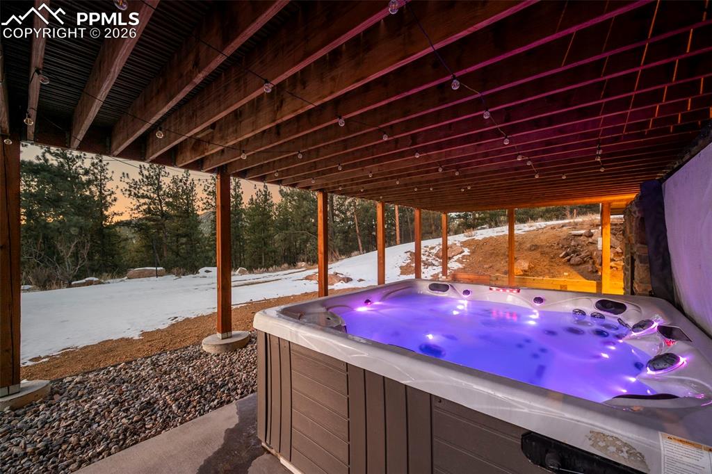 Image 36 of 50: Back covered patio with 8 person Master Spa Hot Tub with a new cover.