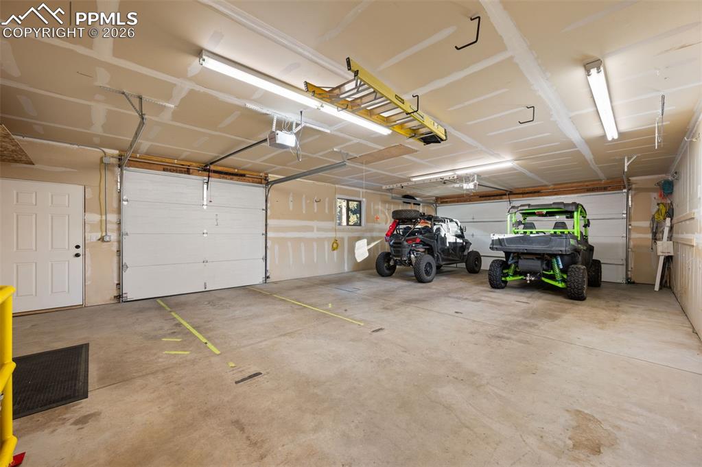 Image 38 of 50: Fully drywalled, insulated and heated oversized three car garage. Also has