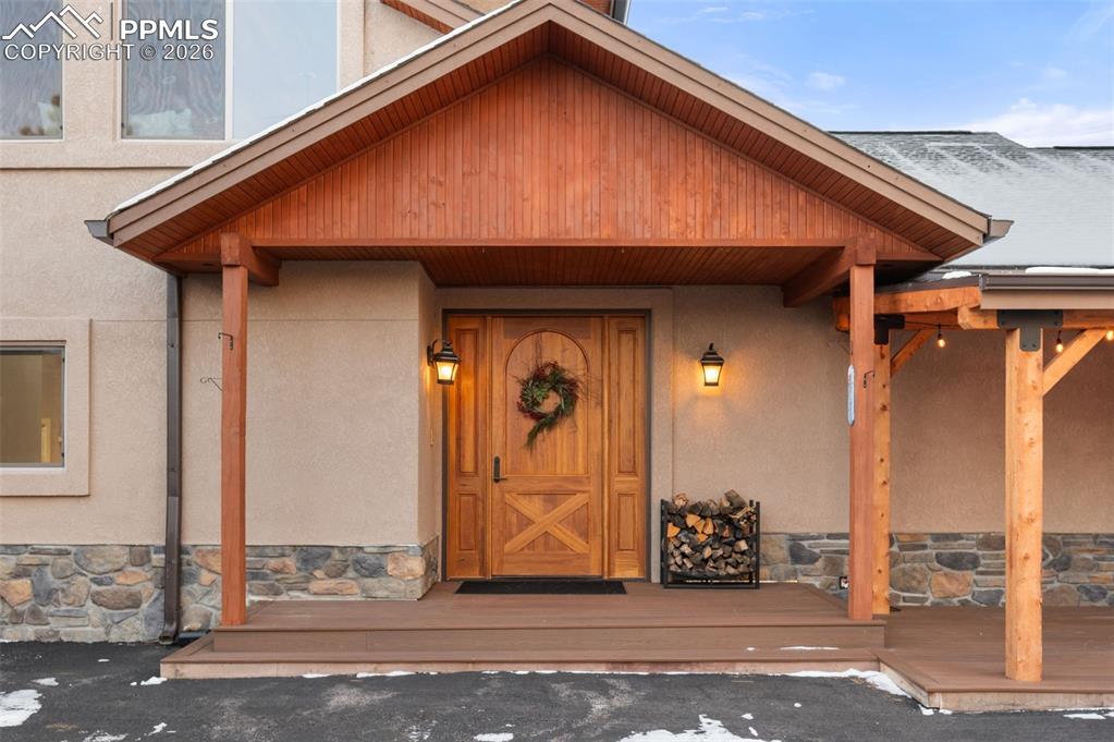 Image 5 of 50: Front entrance with custom mahogany door.