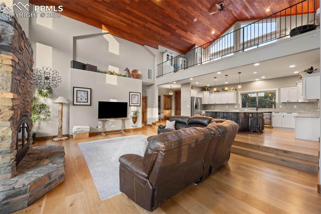Image 9 of 50: Open concept living room and kitchen with view of the loft