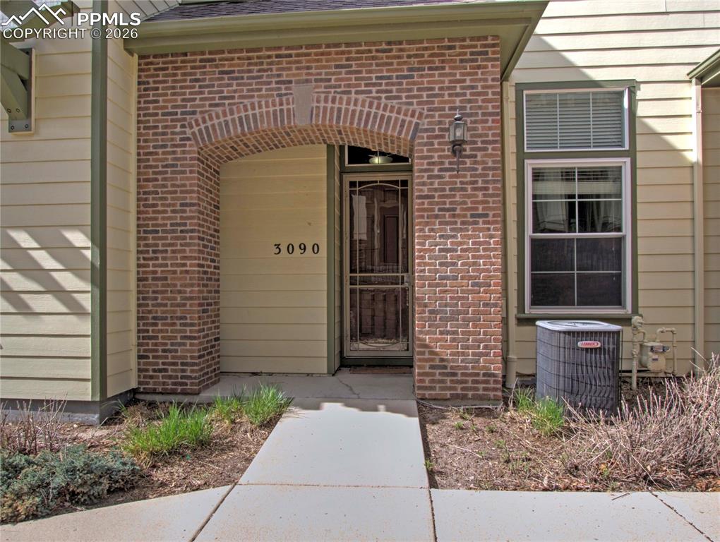Image 1 of 27: View of exterior entry with brick siding