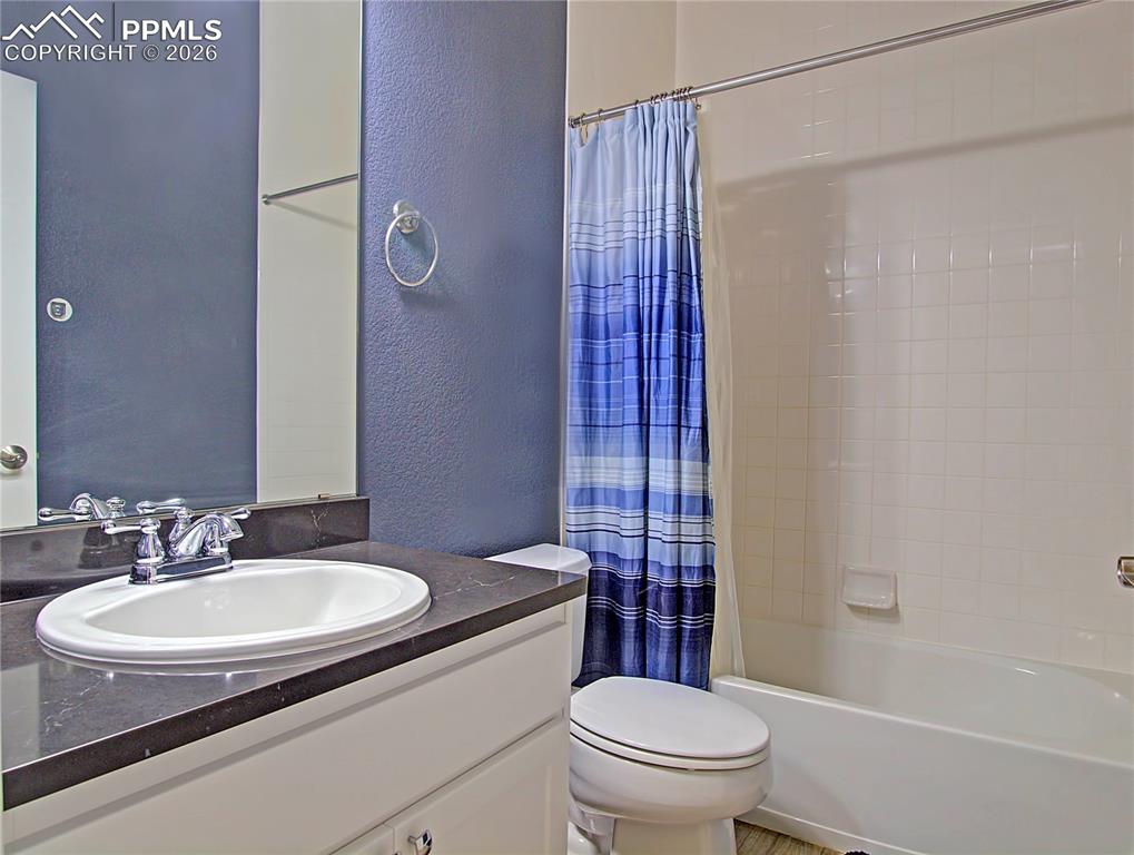 Image 19 of 27: Bathroom featuring a textured wall, vanity, and shower / bathtub combinatio