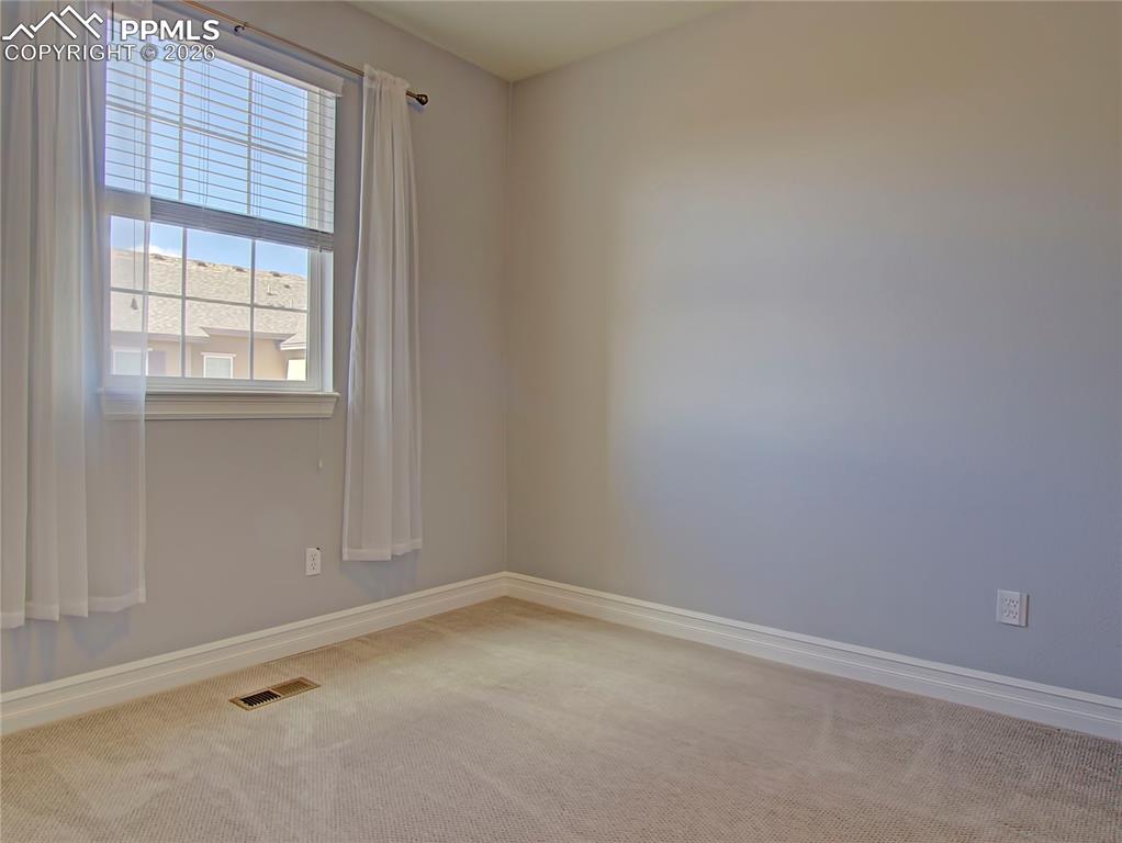 Image 21 of 27: Spare room with light colored carpet and baseboards