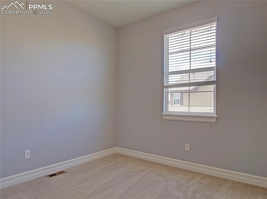 Image 22 of 27: Spare room featuring light colored carpet and baseboards