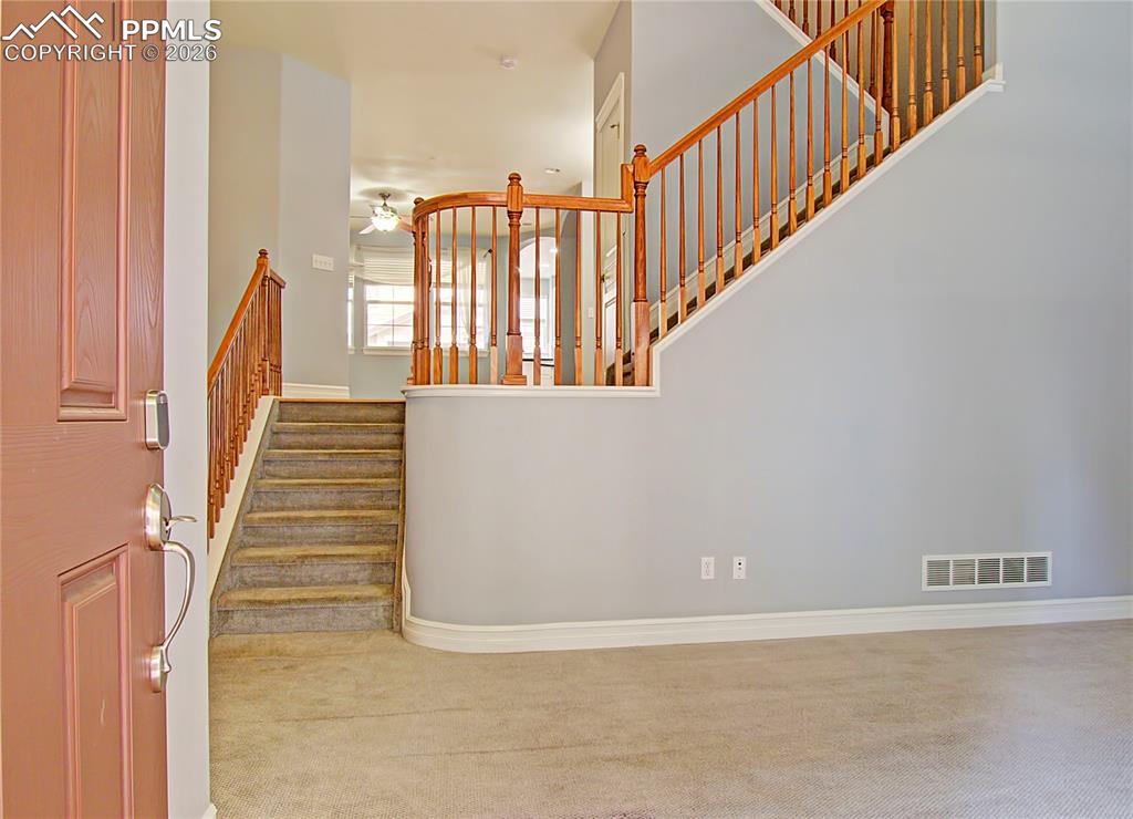 Image 3 of 27: Staircase with carpet flooring and a ceiling fan