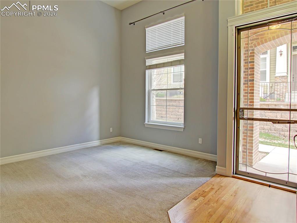 Image 4 of 27: Unfurnished room with baseboards and light wood-type flooring