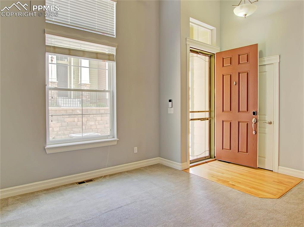 Image 6 of 27: Entryway with light colored carpet