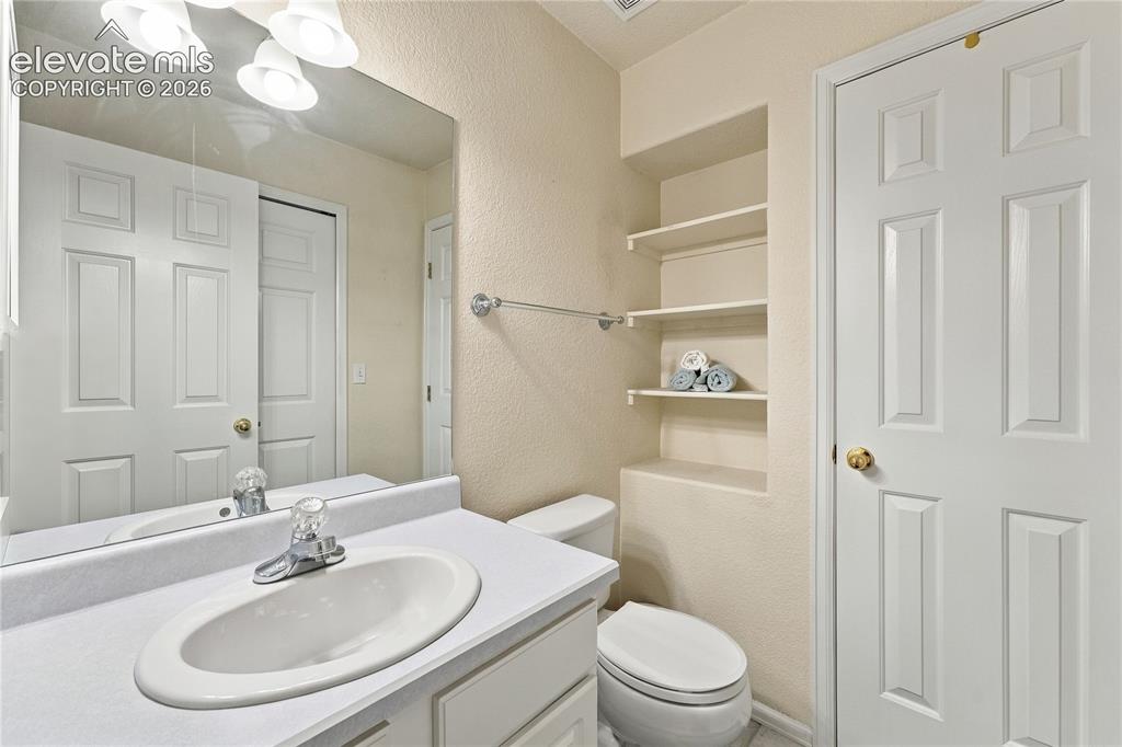 Image 16 of 29: Main level bathroom with stackable Laundry