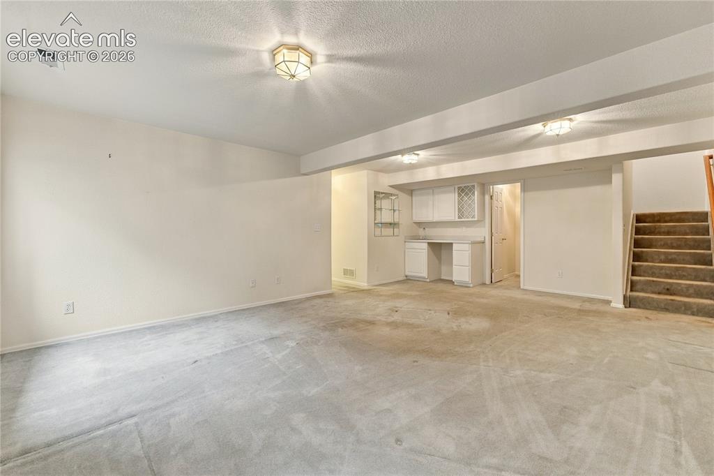 Image 17 of 29: Basement with wet bar
