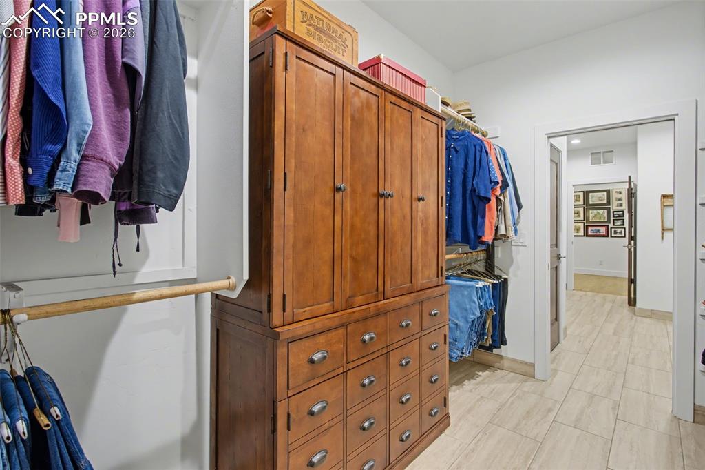 Image 18 of 41: Huge walk in closet connecting to the laundry room