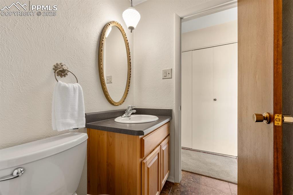 Image 20 of 50: Half bath featuring a textured wall and vanity
