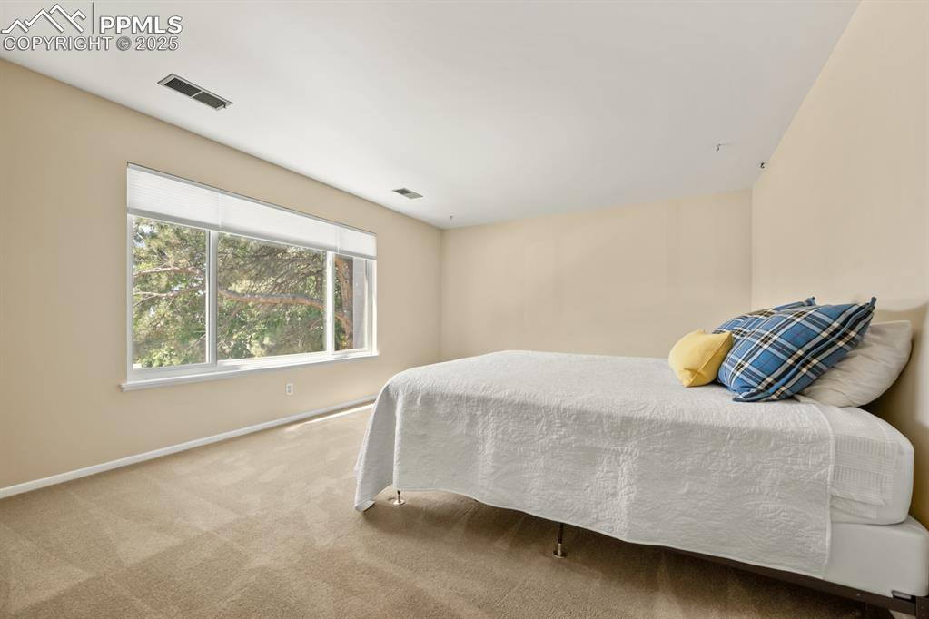 Image 29 of 50: Bedroom featuring carpet floors and baseboards