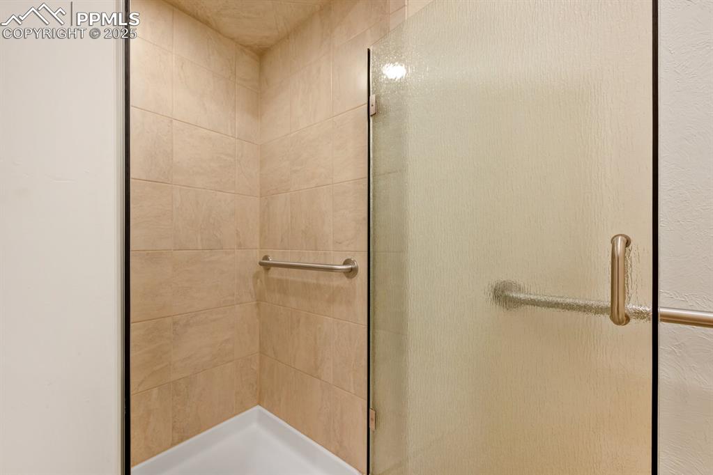 Image 36 of 50: Full bath with a shower stall