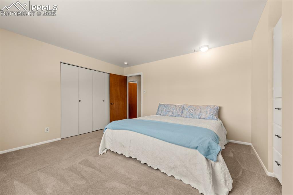 Image 39 of 50: Carpeted bedroom with a closet and baseboards