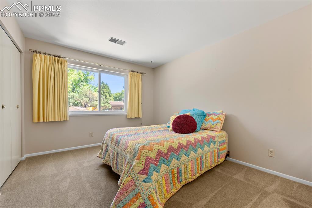 Image 40 of 50: Bedroom with carpet and a closet