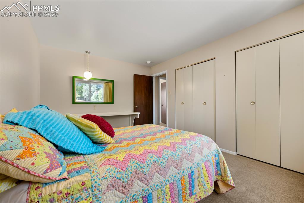 Image 41 of 50: Bedroom featuring multiple closets and carpet