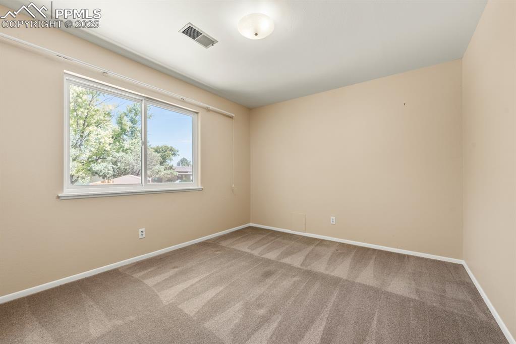 Image 42 of 50: Unfurnished room featuring carpet floors and baseboards