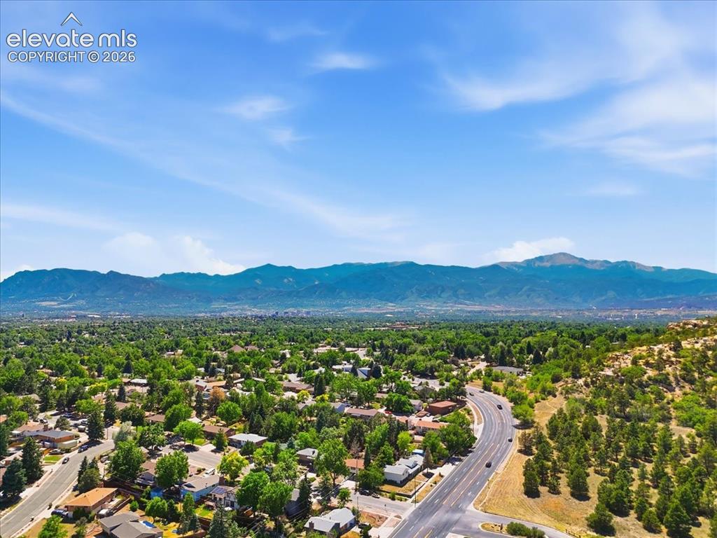 Image 43 of 45: Expansive mountain range backdrop and verdant landscape