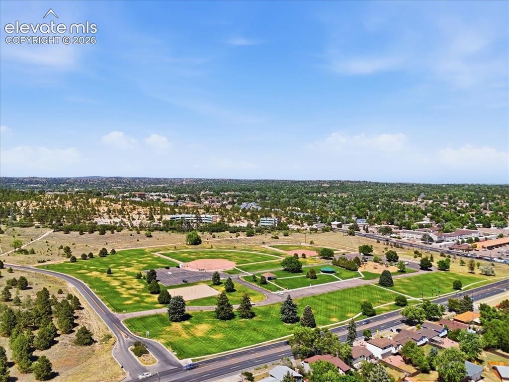 Image 44 of 45: Expansive green spaces featuring multiple sports fields, paved pathways, ma