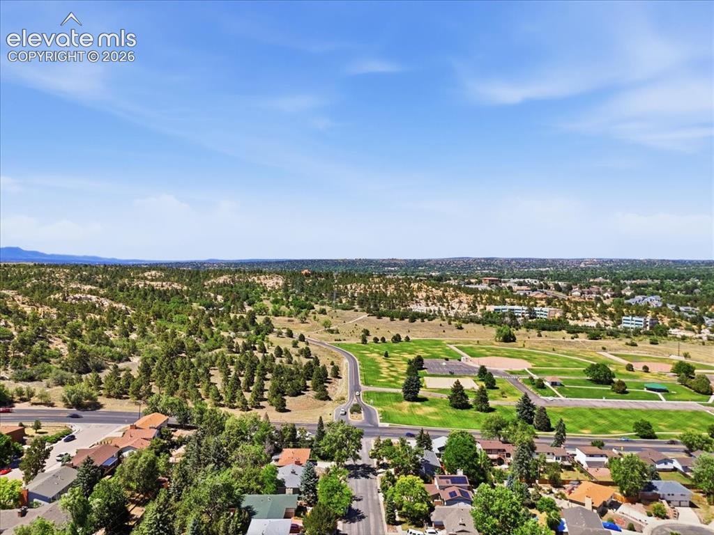 Image 45 of 45: Expansive aerial perspective capturing a residential neighborhood bordered