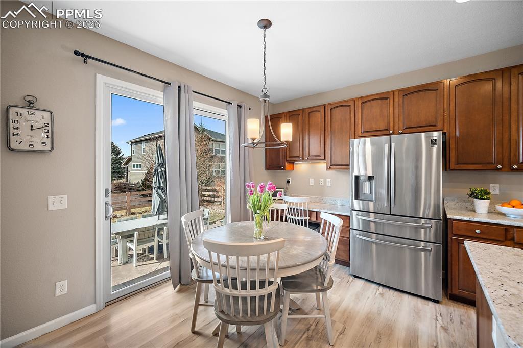 Image 13 of 48: Eat-in space walks out to the back patio and fully fenced back yard. 