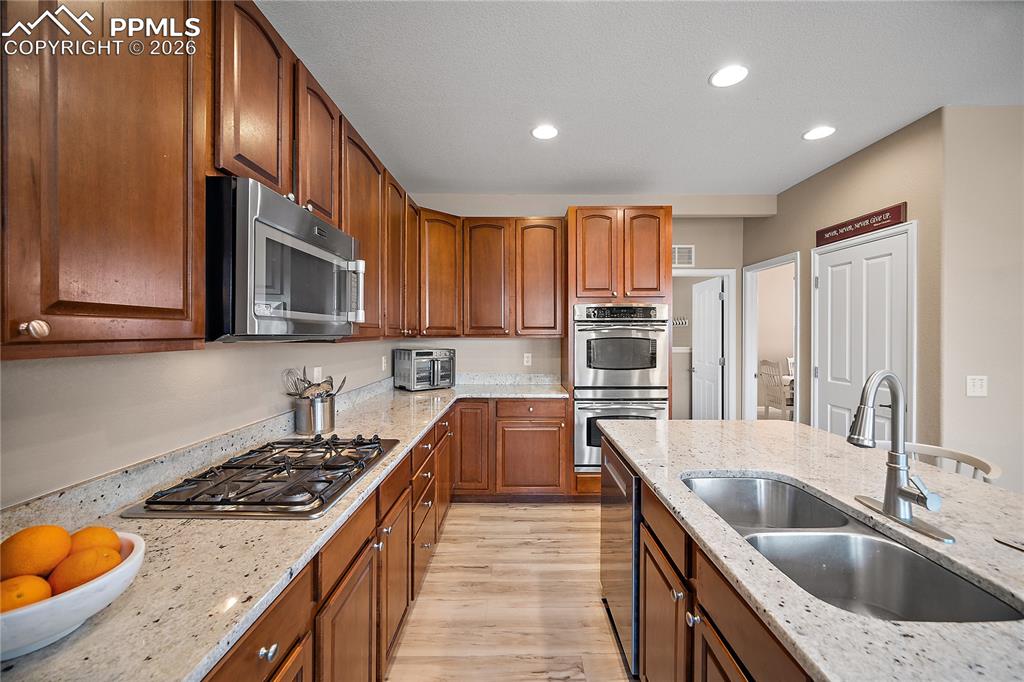 Image 15 of 48: Gas range, double oven, pantry. 